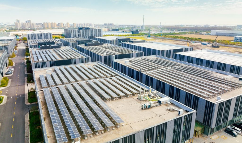 Aerial view of solar panels on factory roof - energy storage system